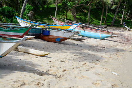 Sri Lankan boats on sandy beach in Tangalle, Southern Province, Sri Lanka, Asia.のeditorial素材