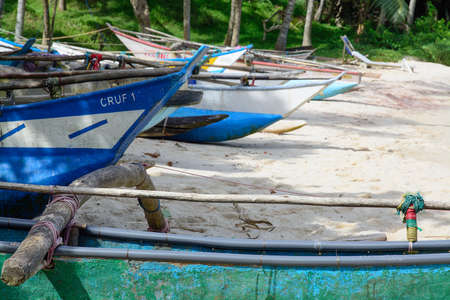 Sri Lankan boats on sandy beach in Tangalle, Southern Province, Sri Lanka, Asia.のeditorial素材
