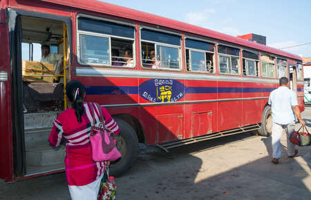 TANGALLE, SOUTHERN PROVINCE, SRI LANKA - DECEMBER 15, 2014: Red bus in Tangalle on December 15 2014 in Tangalle, Southern Province, Sri Lanka, Asia.のeditorial素材