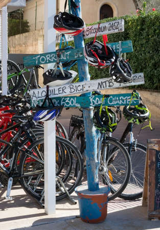 PORT DE SOLLER, MAJORCA, SPAIN - OCTOBER 25, 2013: Bike rental agency with fun promotional signs in the port on October 25, 2013 in Port de Soller, Majorca, Spain.のeditorial素材