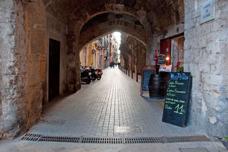 PALMA DE MALLORCA, SPAIN - FEBRUARY 8, 2013: Palma alley restaurant. Restaurant offer of Menu del dia in an alley on February 8, 2013 in Palma de Mallorca, Spain.のeditorial素材