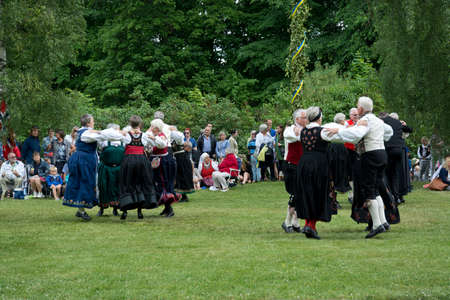 ALSTER, KARLSTAD, SWEDEN - JUNE 20, 2014: People at Midsummer celebrations and Norwegian - Swedish wedding on June 20, 2014 in Alster, Karlstad, Sweden.のeditorial素材