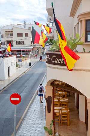 CALA RATJADA, MALLORCA, BALEARIC ISLANDS, SPAIN - JULY 20, 2014: German tourists celebrate their World Championship Gold Medal soccer team with flags on July 20, 2014 in Cala Ratjada, Mallorca, Balearic islands, Spain.のeditorial素材