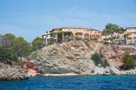 MAJORCA COAST, BALEARIC ISLANDS, SPAIN - JULY 19, 2014: Charming hotels and apartment buildings from the sea near Cala Fornells on July 19, 2014 in southwest Majorca, Spain.のeditorial素材