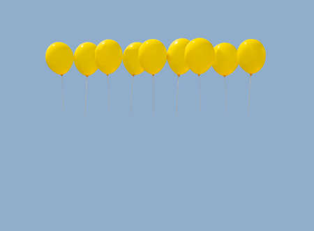 Nine yellow balloons soaring against light blue sky with copy space.
