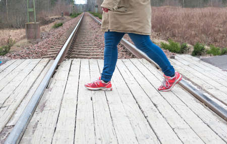 Legs passing railroad tracks perspectiveの写真素材