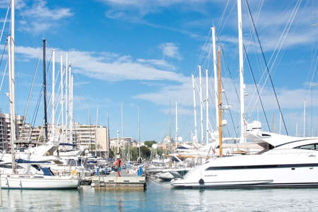 PALMA DE MALLORCA SPAIN  APRIL 19 2015: Pier with moored sailing yachts in the marina and windmill in Santa Catalina in the background on April 19 2015 in Palma de Mallorca Balearic islands Spain.のeditorial素材