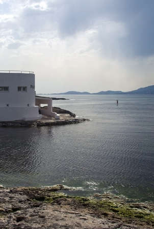 CAN PASTILLA, MALLORCA, SPAIN - APRIL 22, 2015: Solo paddleboard surfer outside Puro Beach on a sunny spring day on April 22, 2015 in Cala Estancia, Mallorca, Balearic islands, Spain.のeditorial素材