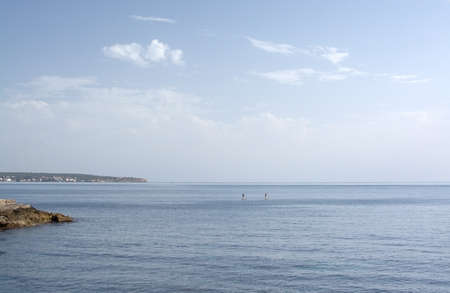 CAN PASTILLA, MALLORCA, SPAIN - APRIL 22, 2015: Couple paddleboarding on blue sea on a sunny spring day on April 22, 2015 in Cala Estancia, Mallorca, Balearic islands, Spain.のeditorial素材