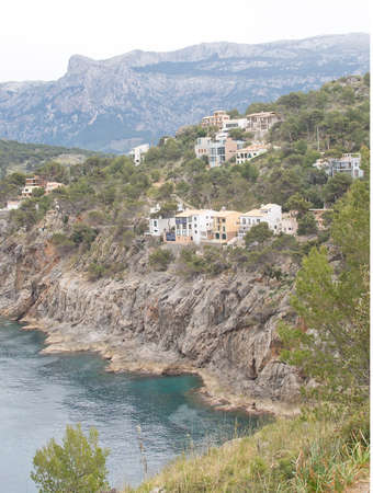PORT DE SOLLER, MALLORCA, SPAIN - APRIL 22, 2015: Attractive first line real estate on the steep slopes by the bay inlet on April 22, 2015 in Port de Soller, Mallorca, Balearic islands, Spain.のeditorial素材