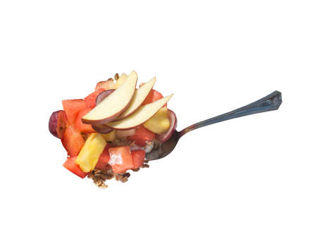 Fruit salad with spoon isolated on white.の写真素材