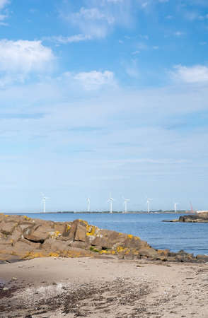 FALKENBERG, SWEDEN - JUNE 5, 2015: Wind turbines in rocky coastal ocean landscape by ocean on June 5 in Falkenberg, Sweden.のeditorial素材