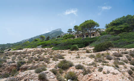 DRAGONERA MALLORCA SPAIN  JULY 19 2014: Dragonera view with building by Cova des Vell Mari on July 19 2014 in Dragonera Mallorca Balearic islands Spain.のeditorial素材