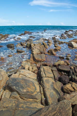 Rocky coast landscape with metamorphic rocks and splashing foaming waves Southern Province Sri Lanka Asia.の写真素材