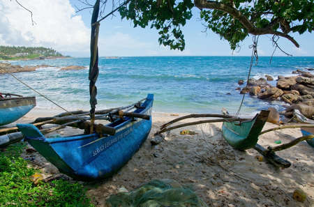 TANGALLE SRI LANKA  DECEMBER 12 2015: Beach with small colorful light wood boats on the Rocky Point beach on December 12 2015 in Tangalle Sri Lanka.のeditorial素材
