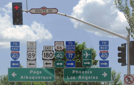FLAGSTAFF, ARIZONA, UNITED STATES - JULY 24, 2008: Road signs at a crossroad on Route 66 with red light going east or west on July 24, 2008 in Flagstaff, Arizona, United States.のeditorial素材