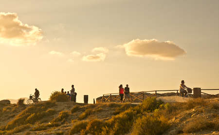 CAN PASTILLA, MAJORCA - JULY 21, 2014: People enjoy golden sunset skies in a sunny summer evening in Es Carnatge on July 21, 2014 in Can Pastilla, Majorca, Spain.のeditorial素材