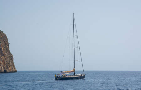 SANTA PONSA, MAJORCA - JULY 19, 2014: Sailboat engines out towards the Mediterranean horizon  on a sunny day off the coast on July 19, 2014 outside Mallorca, Balearic islands, Spain.のeditorial素材