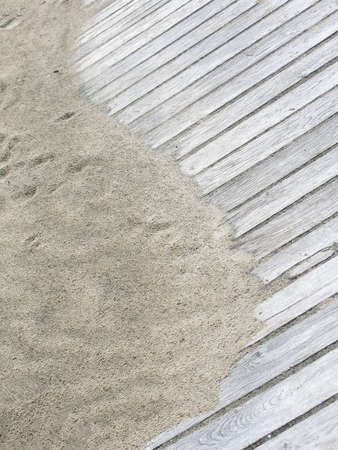 Rustic Yin Yang shape on sandy boardwalk vertical image.の写真素材
