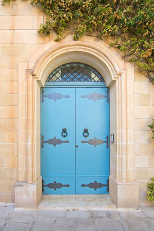 Blue door with iron knobs. Painted doors of Malta series.の写真素材