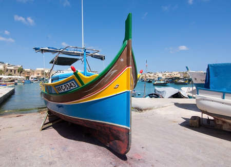 MARSAXLOKK, MALTA - SEPTEMBER 15, 2015: Colorful painted wood boat with the typical protective eye on a sunny day in September 15, 2015 in Marsaxlokk, Malta.のeditorial素材