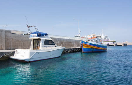 CIRKEWWA, MALTA - SEPTEMBER 16, 2015: Ferry boat moored in the terminal to Gozo and Comino islands on a sunny day in September 16, 2015 in Cirkewwa, Malta.のeditorial素材