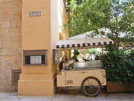 MDINA, MALTA - SEPTEMBER 15, 2015: Restaurant wagon  inside old city walls on a sunny day in September 14, 2015 in Mdina, Malta.のeditorial素材