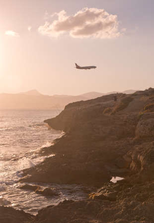 MALLORCA, BALEARIC ISLANDS, SPAIN - JULY 21, 2014: Air Berlin jetliner descends into Palma de Mallorca in a hazy sunny summer evening at dusk on July 21, 2014 in Mallorca, Balearic islands, Spain.のeditorial素材