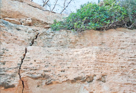 Massive limestone rock formation with cracks in Porto Cristo, Mallorca, Balearic islands, Spain.の写真素材