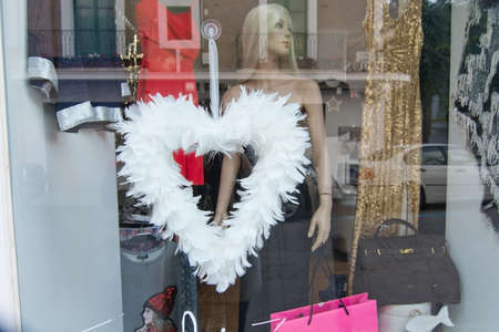 IBIZA, BALEARIC ISLANDS, SPAIN - DECEMBER 15, 2015: Feather heart in festive fashion display window on December 15, 2015 in Ibiza town, Balearic islands, Spainのeditorial素材