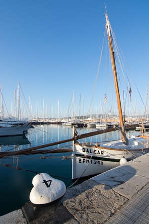 PALMA DE MALLORCA, BALEARIC ISLANDS, SPAIN - DECEMBER 22, 2015: Marina with yachts, llaut  and the...