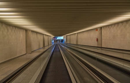 PALMA DE MALLORCA, BALEARIC ISLANDS, SPAIN - DECEMBER 18, 2015: Airport treadmill type rolling transport band with fire extinguisher and advertising at the end on December 18, 2015 in Palma de Mallorca, Balearic islands, Spainのeditorial素材