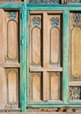 IBIZA, SPAIN - DECEMBER 17, 2015: Floral decor door in green and yellow painted wood on December 17, 2015 in Ibiza, Balearic islands, Spainのeditorial素材