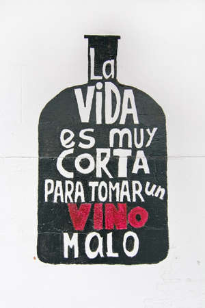 PALMA DE MALLORCA, BALEARIC ISLANDS, SPAIN - DECEMBER 21, 2015: Wall painting - Life is too short to drink bad wine - La Vida es muy corta para tomar un vino malo - in Spanish on December 21, 2015 in Palma de Mallorca, Balearic islands, Spainのeditorial素材