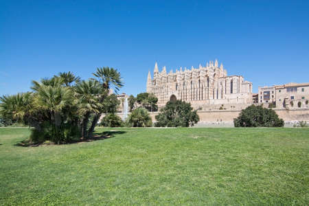 PALMA DE MALLORCA, BALEARIC ISLANDS, SPAIN - APRIL 10, 2016: La Seu cathedral and green grass space on a sunny day in Palma de Mallorca, Balearic islands, Spain on April 10, 2016.のeditorial素材