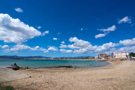 MOLINAR, MALLORCA, SPAIN - MAY 1, 2016: Sandy beach with kids playing in Molinar, Mallorca, Spain on May 1, 2016.のeditorial素材