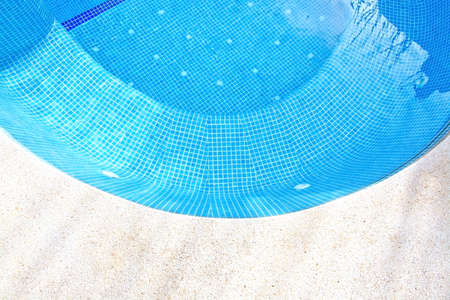 Swimming pool background with concrete and blue tiles in a curve.の写真素材