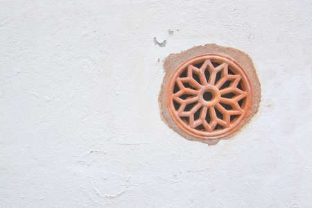 White wall with terracotta ceramic ventilation decor in Mallorca, Balearic islands, Spain.の写真素材