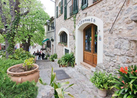 VALLDEMOSSA, MALLORCA, BALEARIC ISLANDS, SPAIN - APRIL 30, 2016: Lush street and Capamunta cafe entrance in Valldemossa, Mallorca, Balearic islands, Spain on April 30, 2016.のeditorial素材