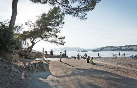SANTA PONSA, MALLORCA, BALEARIC ISLANDS, SPAIN - SEPTEMBER 3, 2016: Beach people and parasols silhouettes on a sunny summer afternoon on September 3, 2016 in Santa Ponsa, Mallorca, Balearic islands, Spain.のeditorial素材