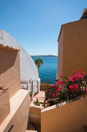 CALA FORNELLS, MALLORCA, SPAIN - SEPTEMBER 6, 2016: Charming architecture and natural landscape in a mix on a sunny day on September 6, 2016 in Cala Fornells, Mallorca, Spain.のeditorial素材