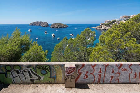 SANTA PONSA, MALLORCA, BALEARIC ISLANDS, SPAIN - SEPTEMBER 3, 2016: Mallorca summer Mediterranean seascape colors with white yachts and Malgrats islets and green vegetation on a sunny summer day on September 3, 2016 in Santa Ponsa, Mallorca, Balearic islaのeditorial素材