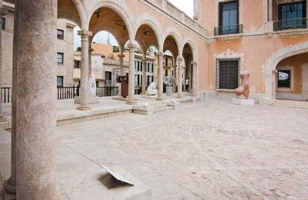 PALMA DE MALLORCA, BALEARIC ISLANDS, SPAIN - JULY 14, 2016: Museu March sculpture garden and neoclassical architecture with a view to Almudaina castle on July 14, 2016 in Palma de Mallorca, Balearic islands, Spain.のeditorial素材