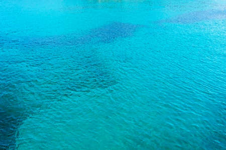 Clear turquoise water background with blue seagrass streaks on a sunny day in Mallorca, Spain.の写真素材