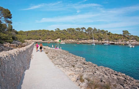 CALA MONDRAGO, MALLORCA, SPAIN - SEPTEMBER 4, 2016: Cala Mondrago and clear turquoise water on a sunny day on September 4, 2016 in Cala Mondrago, Mallorca, Spain.のeditorial素材