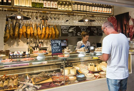 PALMA DE MALLORCA, BALEARIC ISLANDS, SPAIN - SEPTEMBER 22, 2016: Interior food court ham and cheese in Escorxador and Sant Juan Market on September 22, 2016 in Palma de Mallorca, Balearic islands, Spain.のeditorial素材