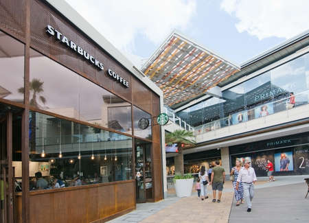 PALMA DE MALLORCA, BALEARIC ISLANDS, SPAIN - SEPTEMBER 29, 2016: Starbucks with shoppers in FAN Shopping Centre on a sunny day on September 29, 2016 in Palma de Mallorca, Balearic islands, Spain.のeditorial素材