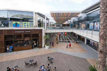 PALMA DE MALLORCA, BALEARIC ISLANDS, SPAIN - SEPTEMBER 29, 2016: Store view Starbucks FAN Mallorca with shoppers in FAN Shopping Centre on a sunny day on September 29, 2016 in Palma de Mallorca, Balearic islands, Spain.のeditorial素材