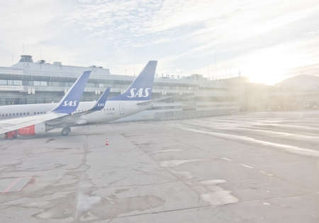STOCKHOLM, SWEDEN - DECEMBER 26, 2016: Scandinavian Airlines jetliners line up outside the gates at...