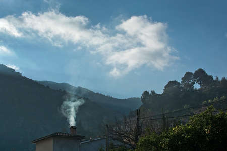 Mallorca landscape with chimney smoke on a sunny winter morning in Januaryの写真素材